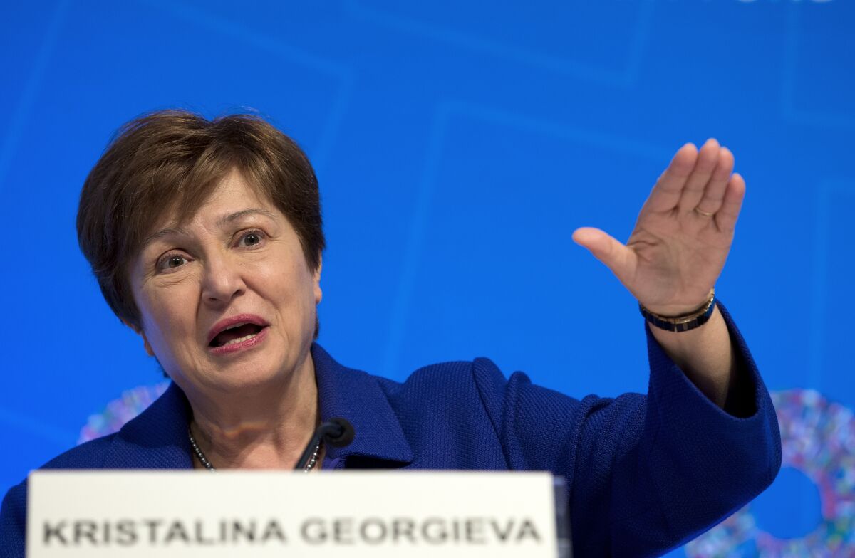 FILE - In this Oct. 19, 2019 file photo, International Monetary Fund Managing Director Kristalina Georgieva speaks during a news conference after the International Monetary and Financial Committee (IMFC) meeting, at the World Bank/IMF Annual Meetings in Washington. Georgieva says the agency is trimming its forecast for global growth this year. On Tuesday, Oct. 5, 2021 Georgieva cited rising risks of inflation, debt and a divergence in growth prospects between nations with access to the coronavirus vaccines and those in need of shots. (AP Photo/Jose Luis Magana, File)