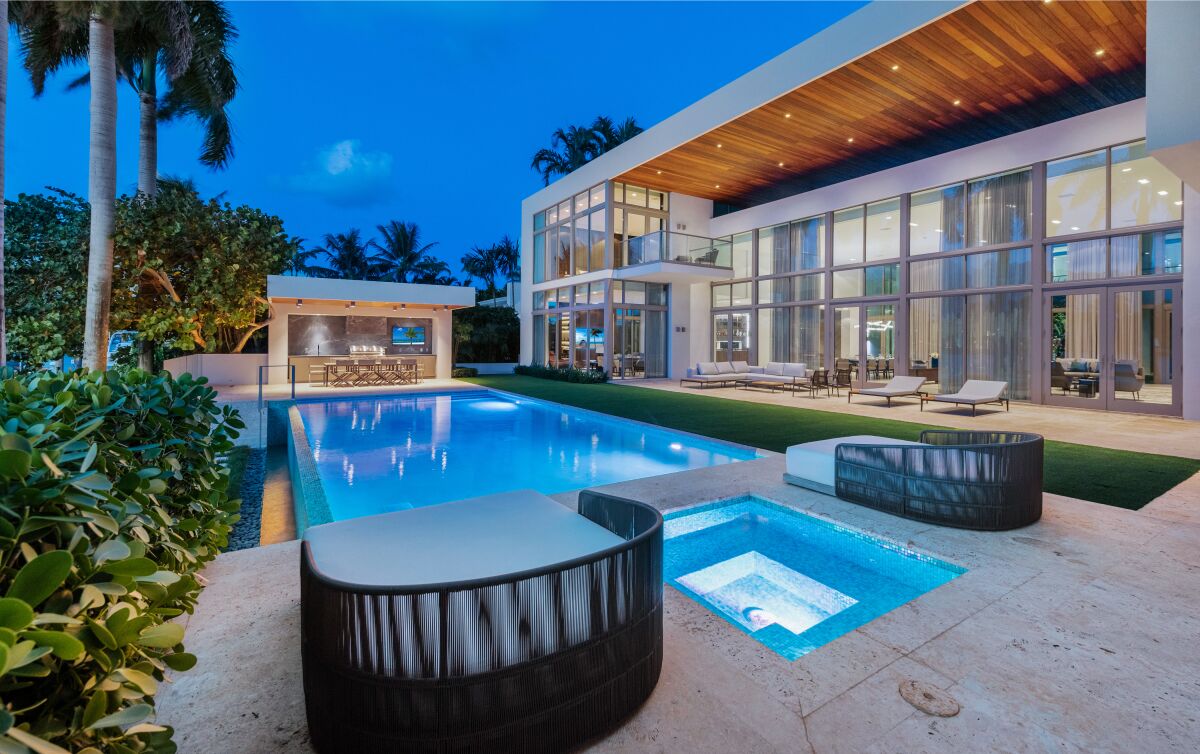 Newly renovated, the boxlike abode overlooks Biscayne Bay with a swimming pool, cabana and private dock.