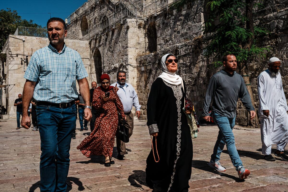 People walk inside the Old City in Jerusalem.