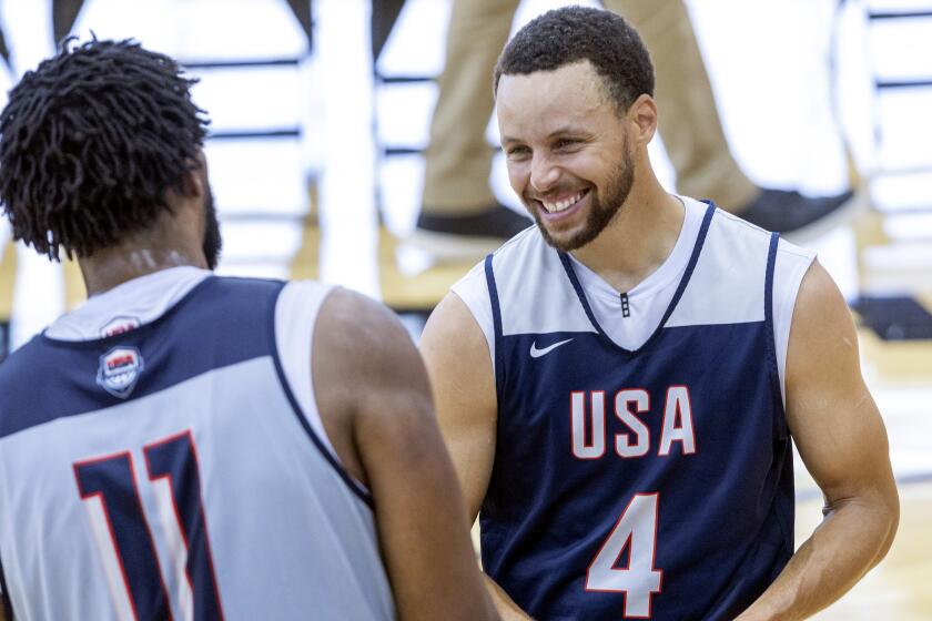 Stephen Curry, right, talks with Joel Embiid during training camp for the United States men's basketball team