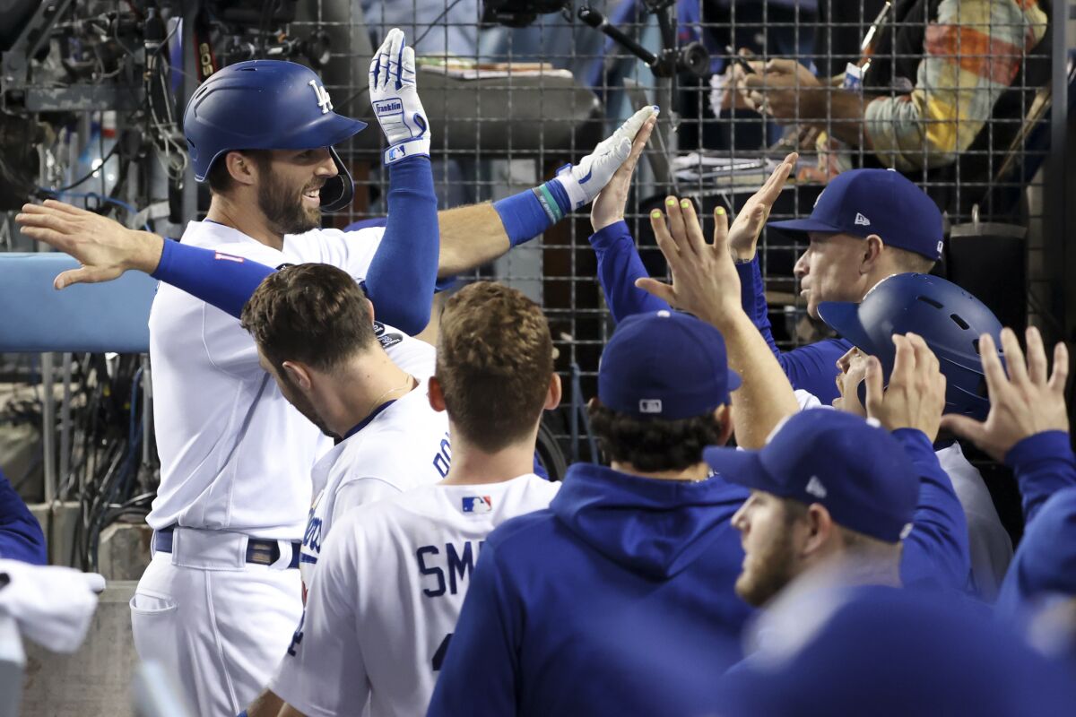 Dodgers' Chris Taylor celebrates with the dugout after a solo home run.