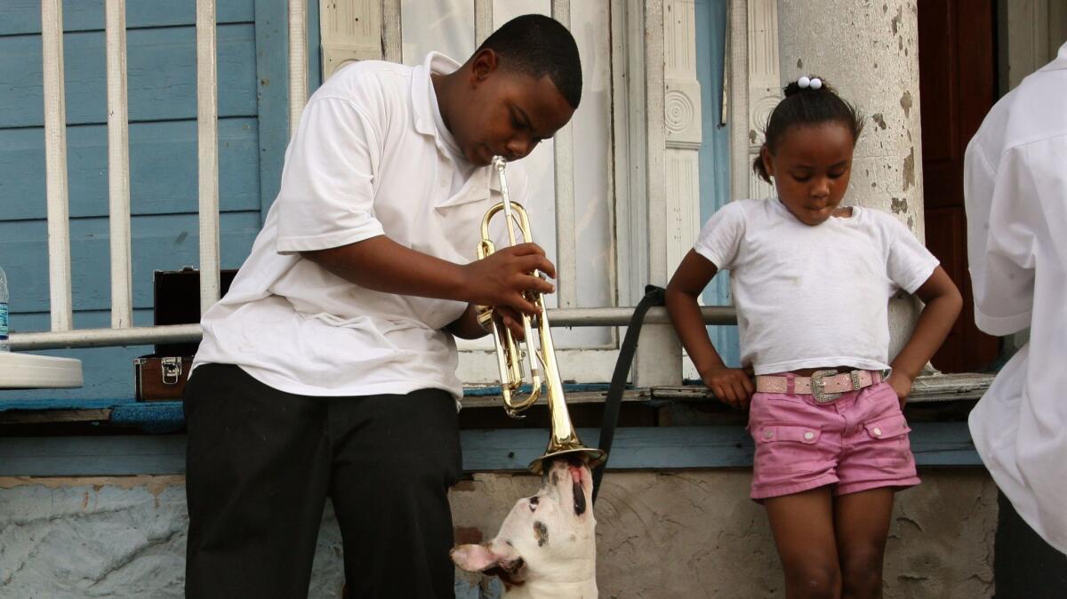 Darvell Ross, left, and his sister, live with extended in the Tremaine area of New Orleans. Seven adults and 15 children share the home of their grandmother. Their dog "Precious" survived the storm.