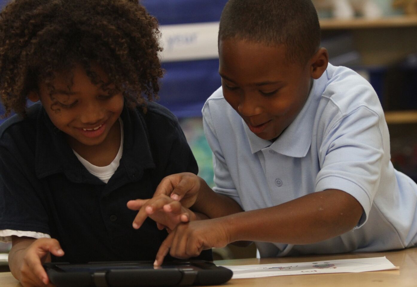 King Shelton, left, and Zylan Giles work with their new iPads at Broadacres Avenue Elementary School in Carson.