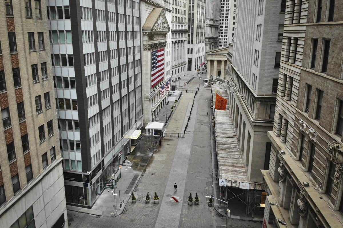 A lone pedestrian passes the New York Stock Exchange on March 21.
