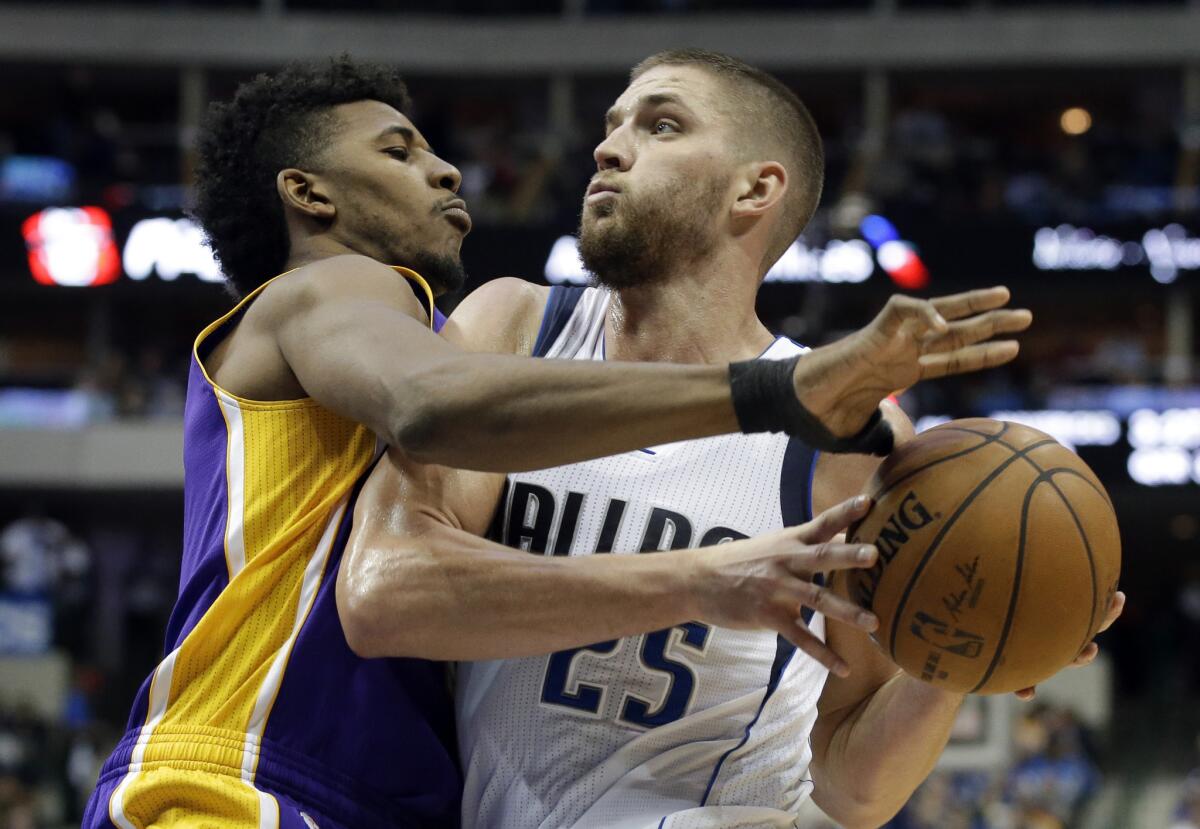Lakers guard Nick Young tries to prevent Mavericks forward Chandler Parsons from scoring during a game on Nov. 21, 2014, in Dallas.