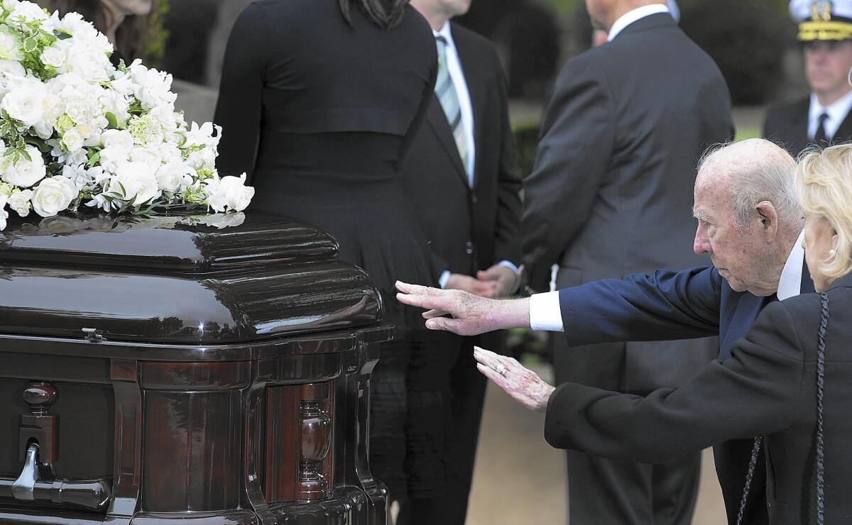 Former Secretary of State George Shultz and his wife, Charlotte Mailliard Swig, reach out to touch Nancy Reagan's casket Friday.