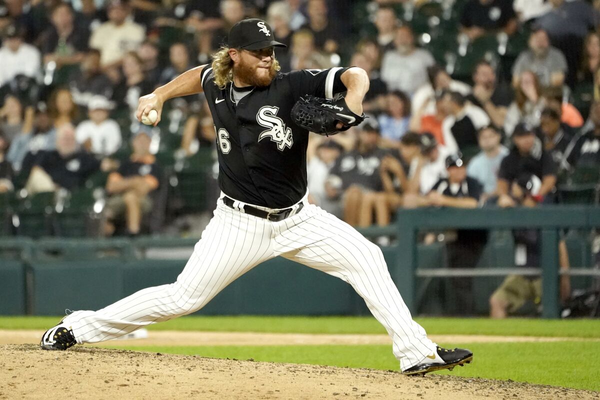 FILE - Chicago White Sox relief pitcher Craig Kimbrel delivers during the eighth inning of a baseball game against the Pittsburgh Pirates Tuesday, Aug. 31, 2021, in Chicago. The White Sox have exercised their $16 million club option for reliever Craig Kimbrel and declined their option on infielder César Hernández.The team announced the moves on Saturday, Nov. 6, 2021.(AP Photo/Charles Rex Arbogast, File)