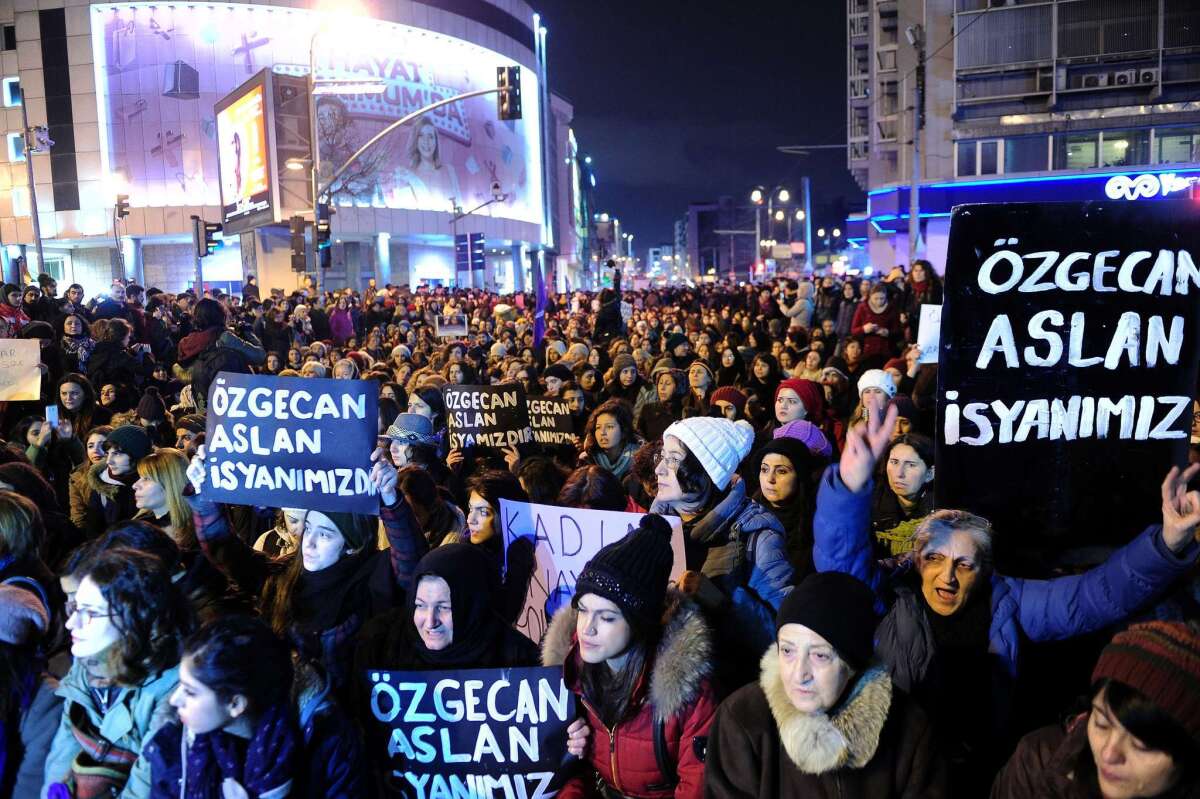 Women shout slogans and hold placards reading "Ozgecan Aslan is our rebellion" during a demonstration in Istanbul on Saturday following the young woman's slaying.