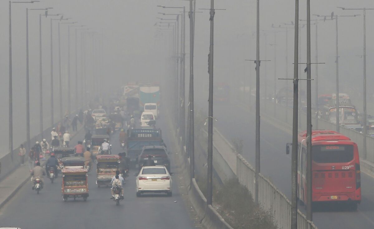 Vehicles drive on a highway as smog envelops the area of Lahore, Pakistan, Wednesday, Nov. 11, 2020. People in Pakistan’s cultural capital of Lahore were at risk of respiratory diseases and eye-related problems Wednesday after the air quality deteriorated to hazardous levels due to a quilt of smog over the city, prompting doctors to urge people to stay at home. (AP Photo/K.M. Chaudary)