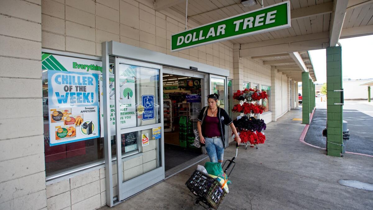 A customer leaves after shopping at a Dollar Tree store in Lakeport, Calif.