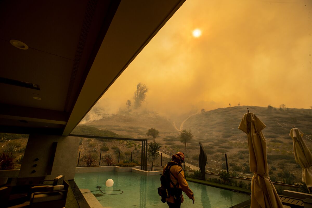 Firefighter awaits the Silverado fire in Irvine