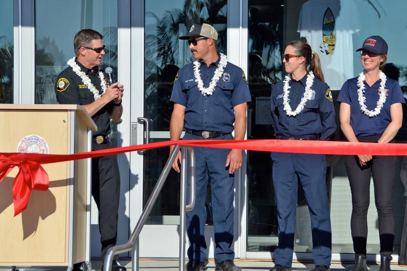 Newport Beach Fire Chief Jeff Boyles introduces Capt. Gary Conwell, Officer Carley Christian and Cynthia Haritatos.