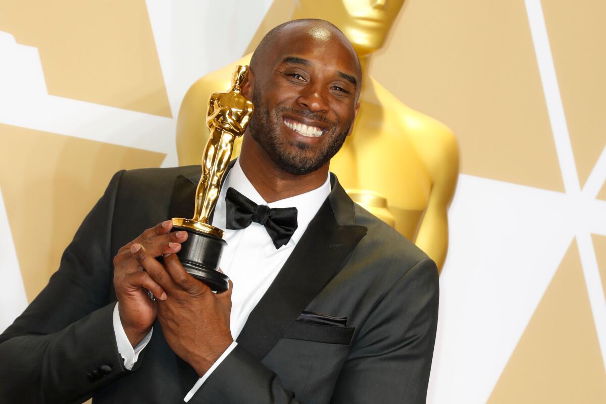 Kobe Bryant holds his 2018 Oscar for "Dear Basketball," which won for best animated short film.