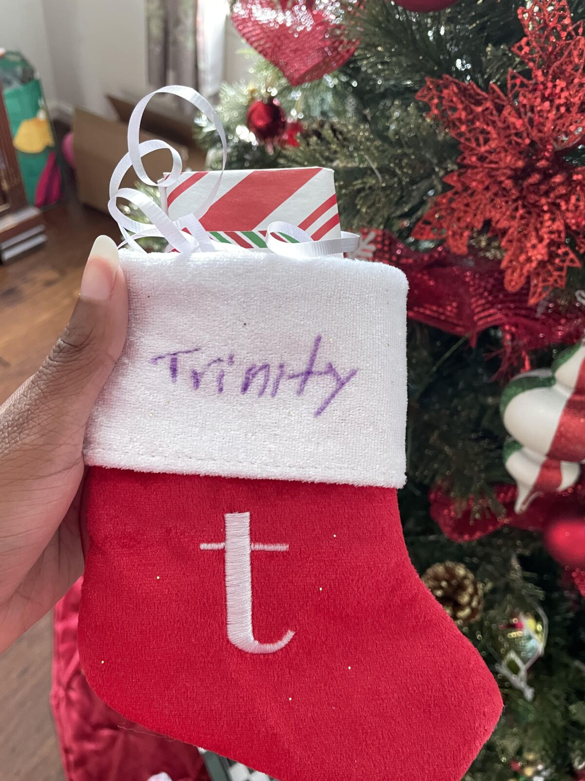 Trinity Alicia hangs her own Christmas stocking last year 2021.