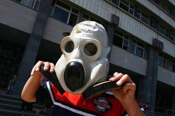 A boy plays with a gas mask outside a Soviet-era Defense Ministry building in Tbilisi, Georgia. Russia and Georgia virtually closed down diplomatic exchanges as the United States prepared a $1-billion postwar aid package for Georgia. In an additional show of U.S. support, Vice President Dick Cheney began a tour of four ex-Soviet states, including Georgia.