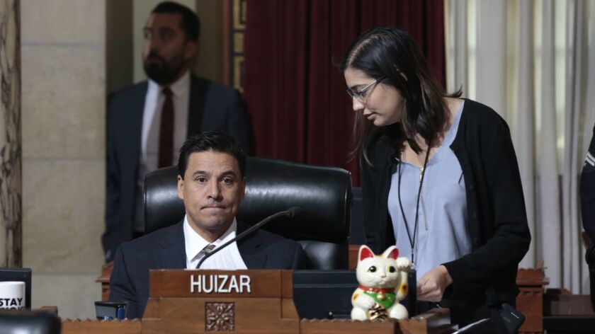 Huizar attends a council meeting in 2018 with an unidentified person next to him.