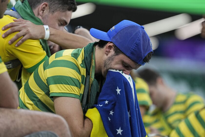 Brazilian fans react on the tribune after losing the World Cup quarterfinal soccer match between Croatia and Brazil, at the Education City Stadium in Al Rayyan, Qatar, Friday, Dec. 9, 2022. (AP Photo/Martin Meissner)
