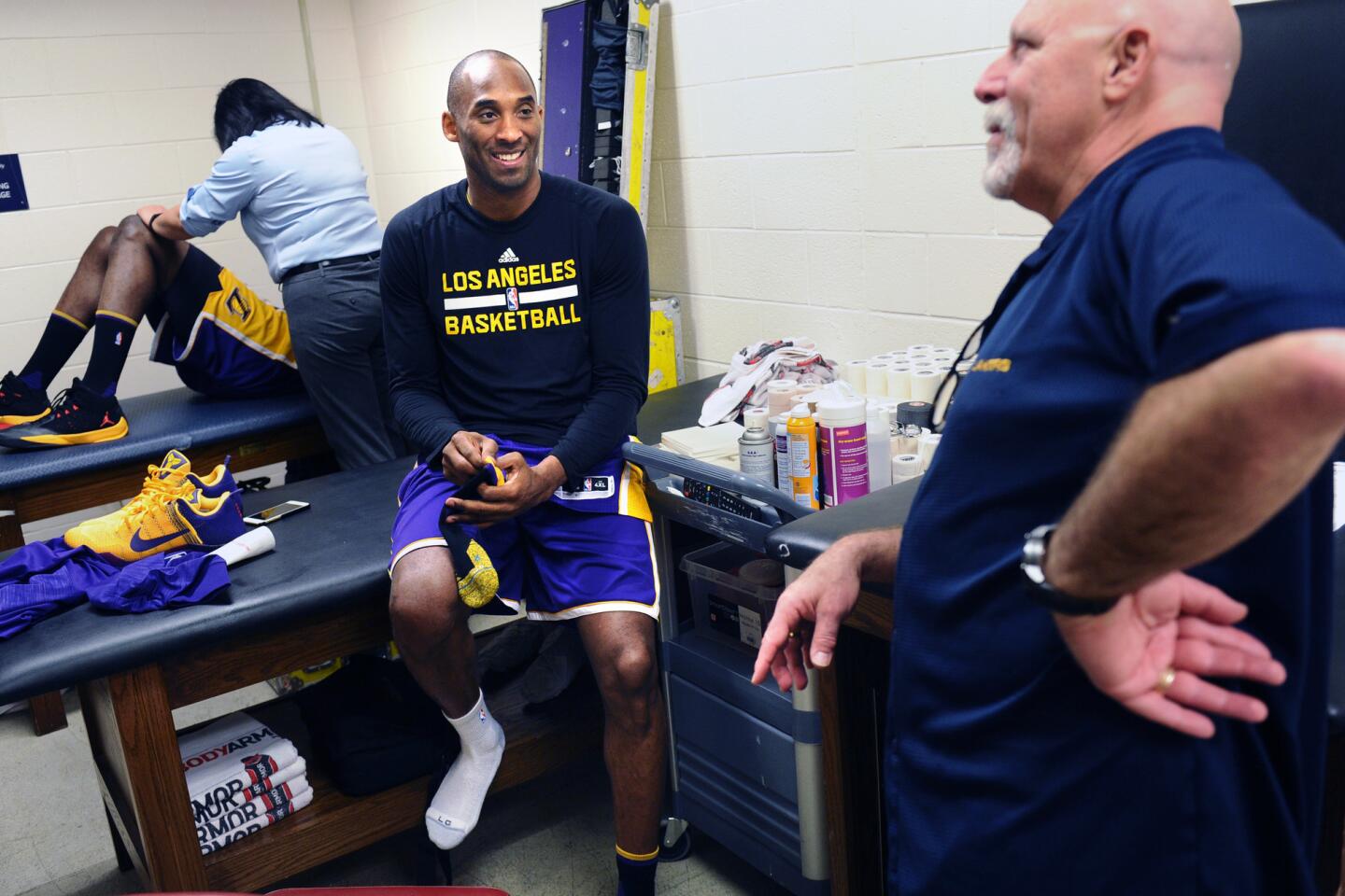 Kobe Bryant and trainer Gary Vitti share a laugh in the locker room before a game against the Rockets in Houston.