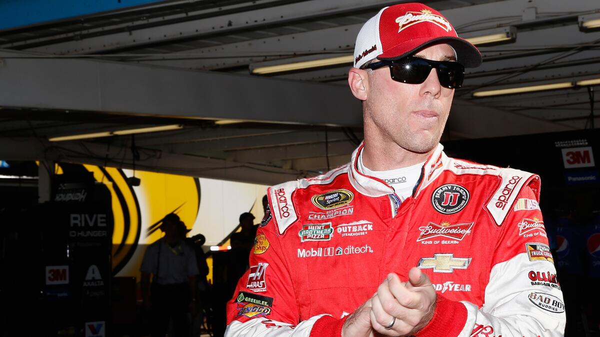 NASCAR driver Kevin Harvick stands in the garage area during practice Friday for the NASCAR Sprint Cup Series Quicken Loans Race for Heroes 500 at Phoenix International Raceway.