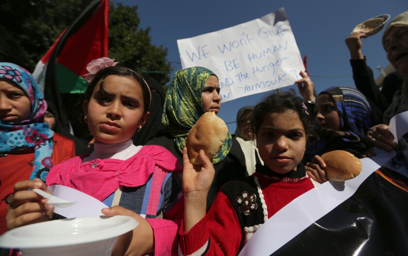 Palestinian children in Gaza City attend a rally in solidarity with Palestinian refugees in Yarmouk refugee camp in Syria on Thursday.