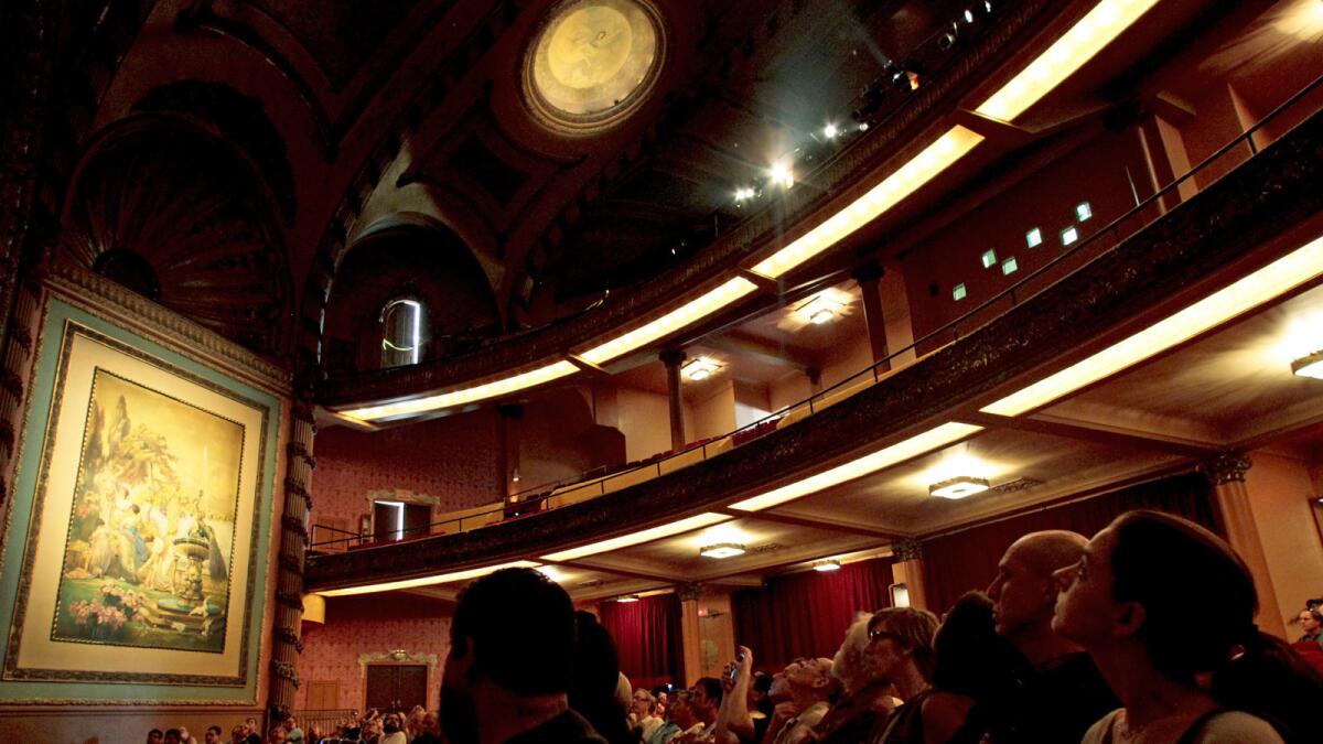 Visitors look at the restored Palace Theatre during a 2012 tour. (Anne Cusack / Los Angeles Times)