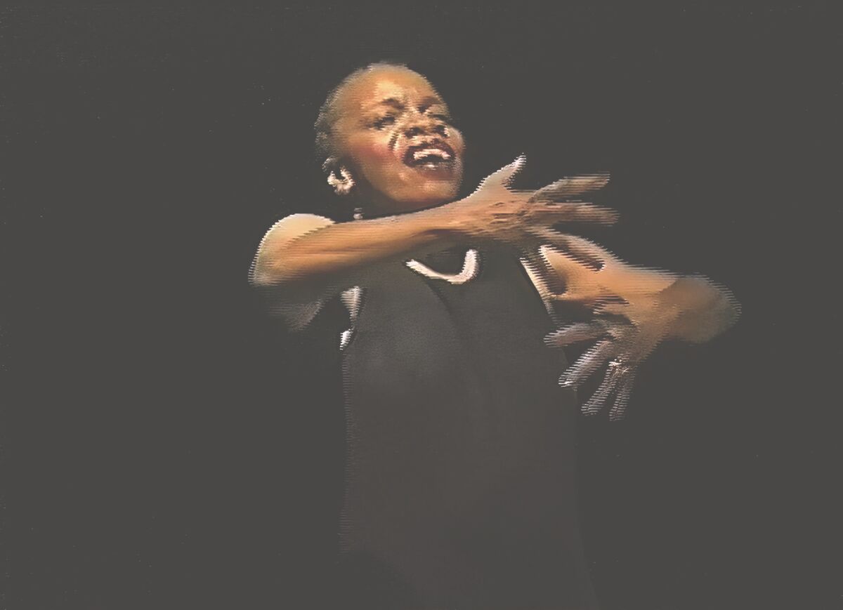 A woman performs a dance move.