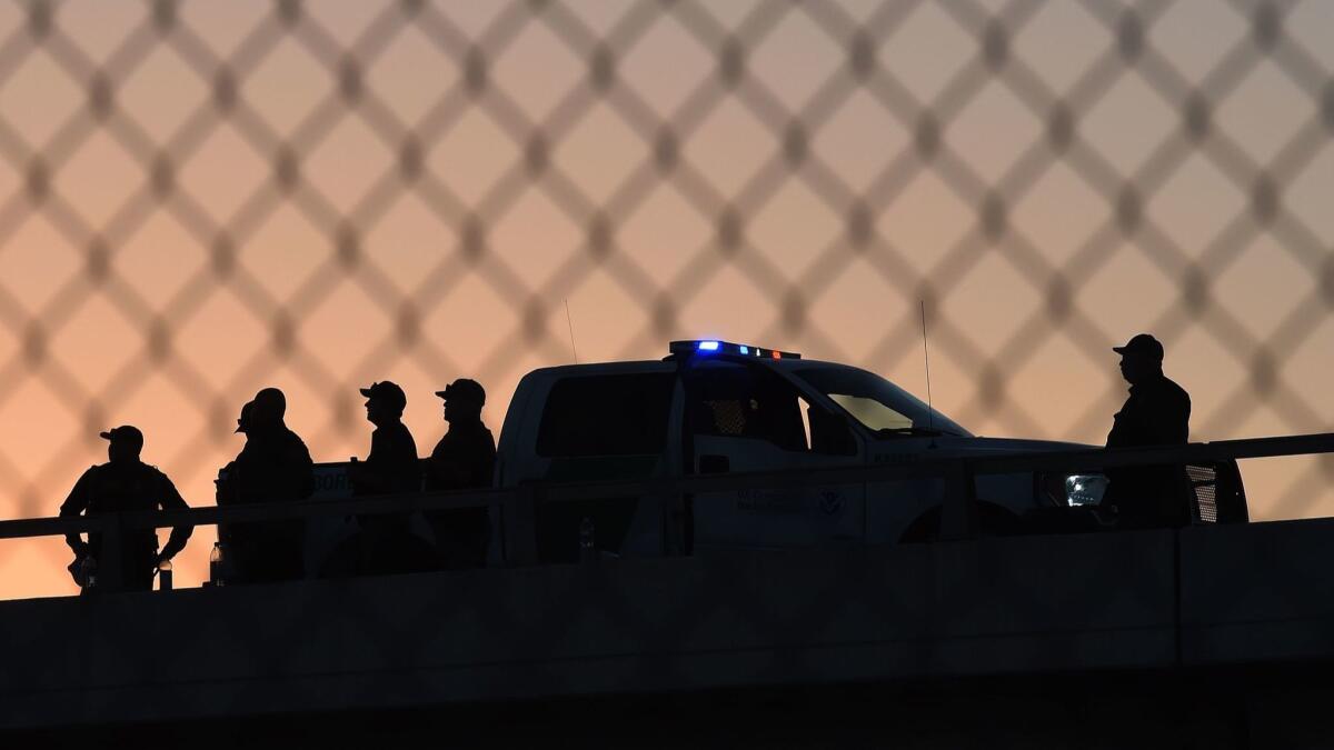 Border Patrol officers guard the U.S.-Mexico border Saturday in El Paso.