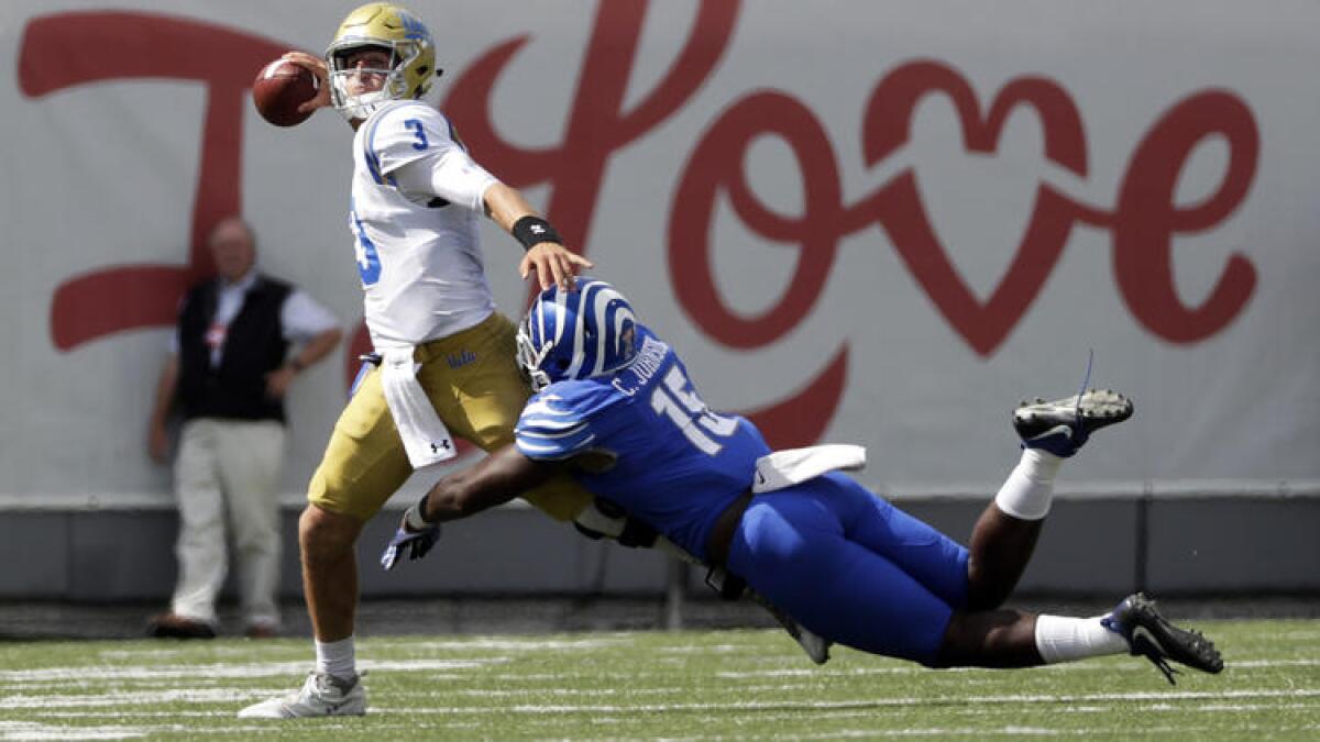 UCLA quarterback Josh Rosen attempts a pass as he is hit by Memphis defensive lineman Christian Johnson during the second half Saturday.