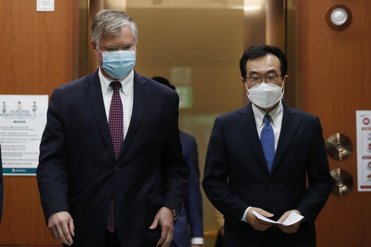 U.S. Deputy Secretary of State Stephen Biegun, left, walks with his South Korean counterpart Lee Do-hoon after their meeting at the Foreign Ministry in Seoul Wednesday, July 8, 2020. Biegun is in Seoul to hold talks with South Korean officials about allied cooperation on issues including North Korea. (Kim Hong-ji/Pool Photo via AP)