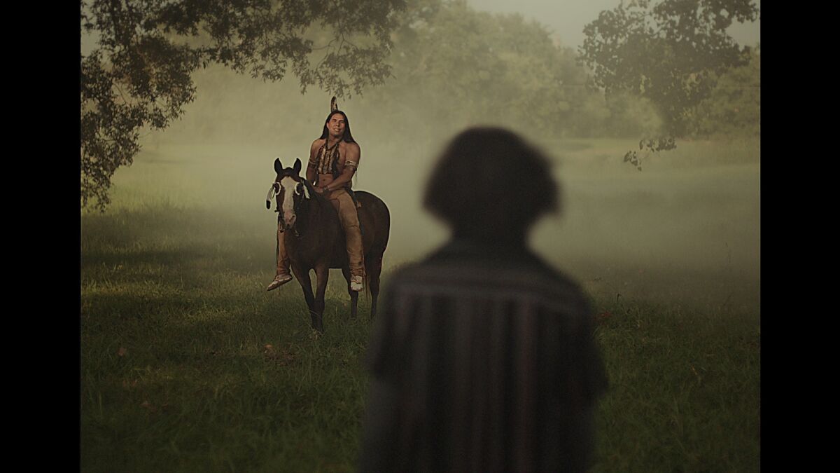 A teenage boy looks out on a 19th century Indigenous man on a horse.