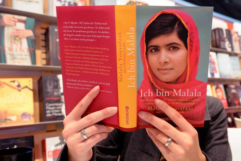A visitor reads the book "Ich bin Malala" (I am Malala) from Malala Yousafzai at the 2013 Frankfurt Book Fair in Germany on Wednesday.