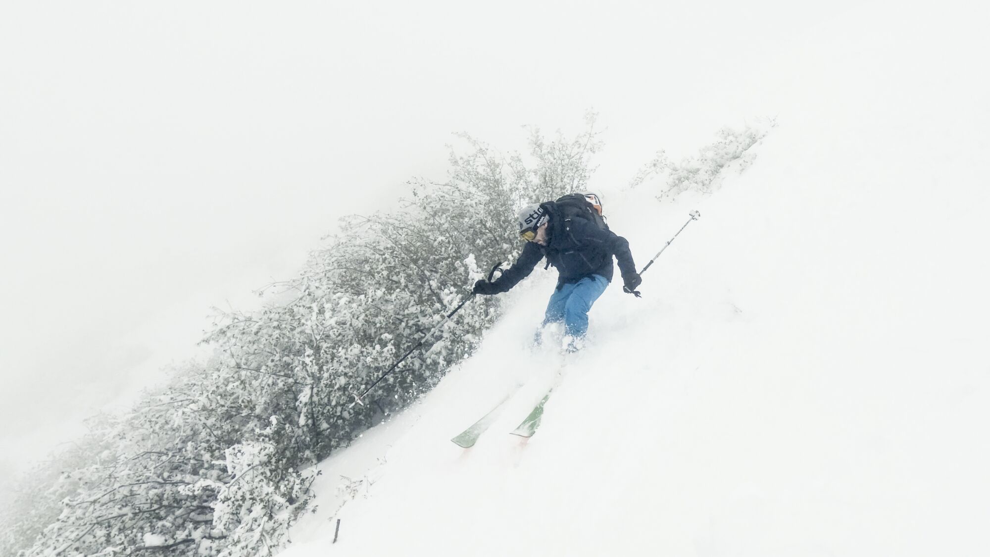 Matthew Testa skis down the west face of Mt. Lukens in white-out conditions.
