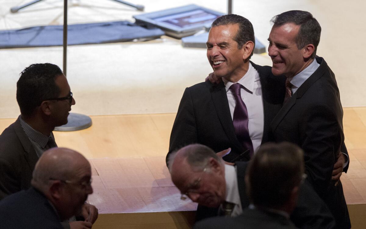 Former L.A. Mayor Antonio Villaraigosa is hugged by current Mayor Eric Garcetti, right, before Kevin de Leon is sworn in as president pro tempore of the state Senate last year. The two Democrats, along with Lt. Gov. Gavin Newsom, have the most support to be the next California governor, according to a new poll.