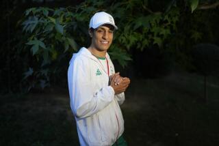 Algerian boxer Imane Khelif poses for a photo after an interview with SNTV at the 2024 Summer Olympics Sunday in Paris.