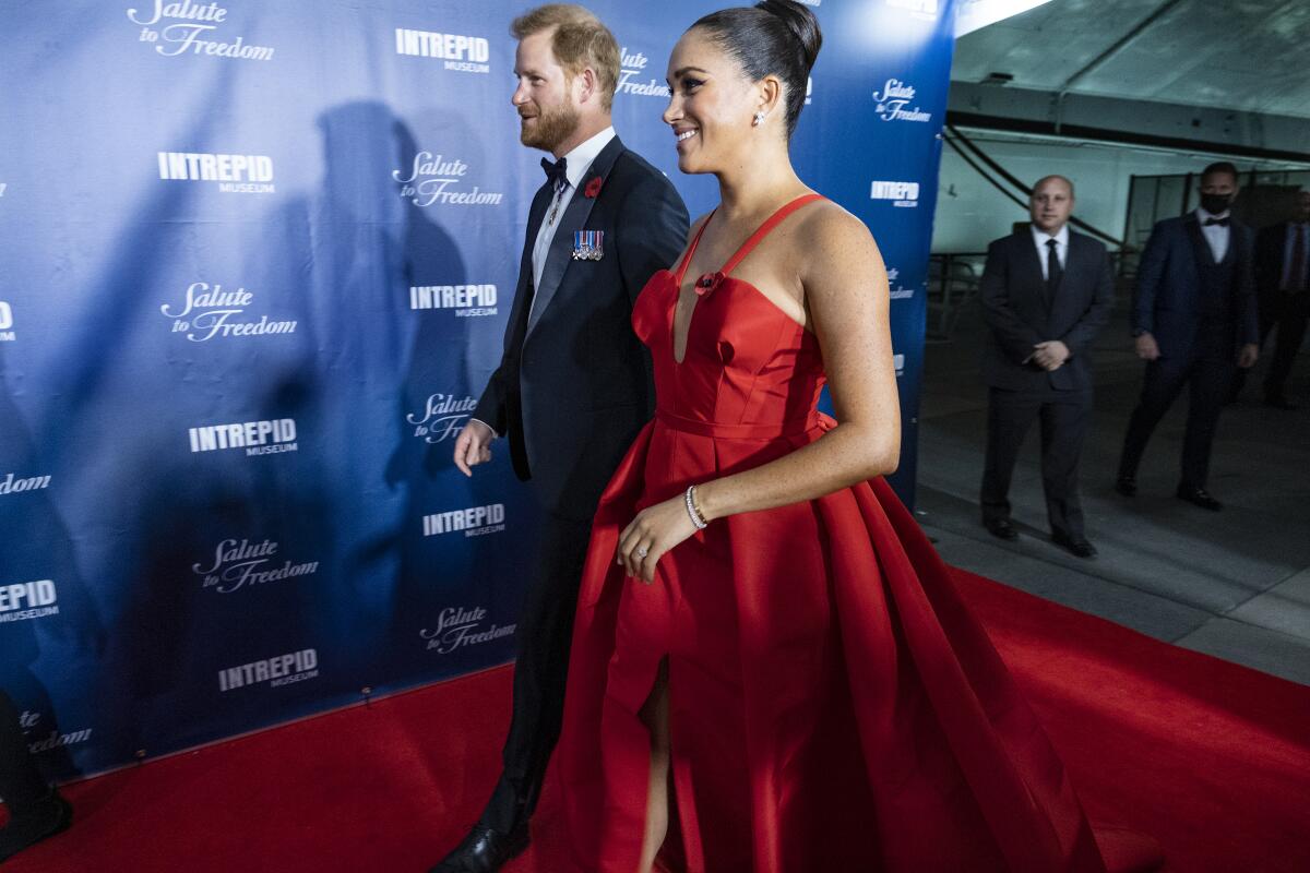 FILE - Prince Harry and Meghan Markle, Duke and Duchess of Sussex, arrive at the Intrepid Sea, Air & Space Museum for the Salute to Freedom Gala Wednesday, Nov. 10, 2021, in New York. The Duchess of Sussex has apologized for misleading a British court about the extent of her cooperation with the authors of a sympathetic book about her and Prince Harry. The former Meghan Markle sued a U.K. newspaper for publishing a letter she wrote to her estranged father, Thomas Markle. (AP Photo/Craig Ruttle)