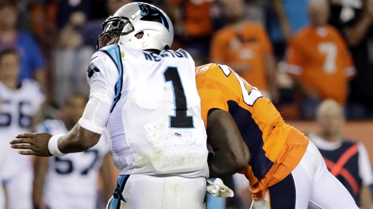 Panthers quarterback Cam Newton recoils as he takes a head-to-head hit from Broncos safety Darian Stewart on Sunday.