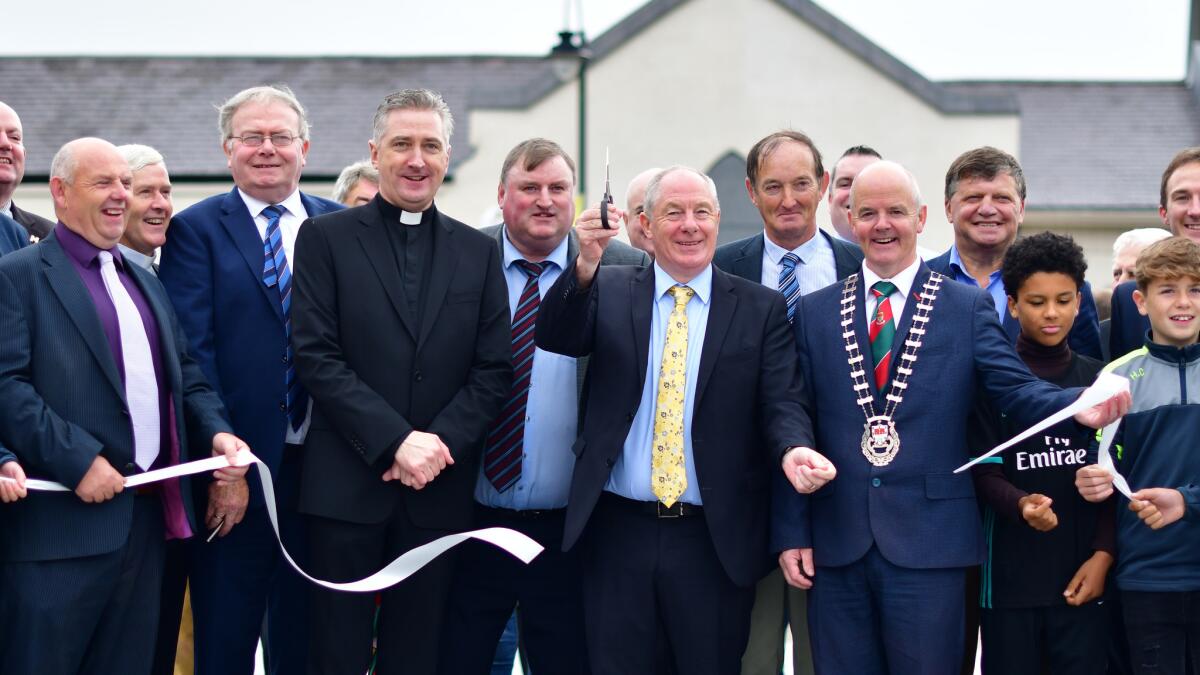 Michael Ring, Ireland's minister for rural and community development, cuts the ribbon at the opening of Pope Francis Plaza in Knock in the west of Ireland on Aug. 21, 2018.