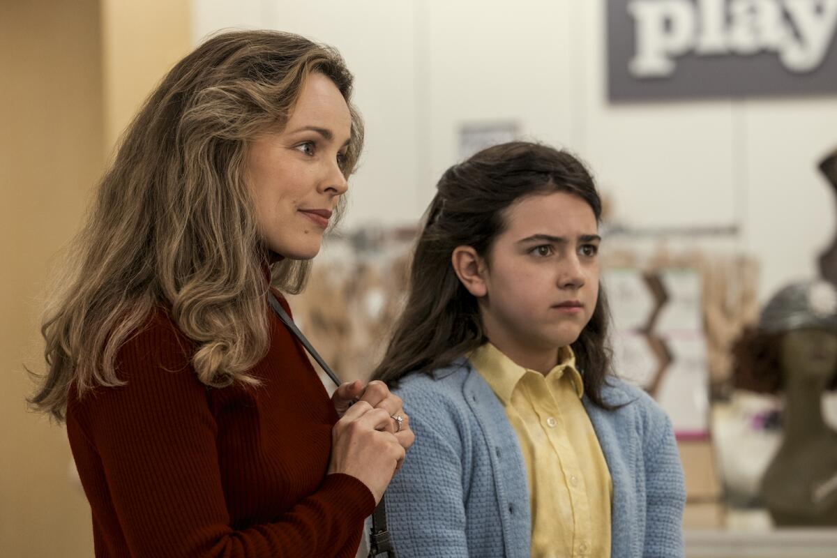 Actors portray a mother and a girl who flashes a look of concern.
