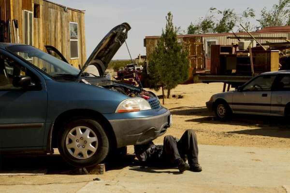 Oscar Castaneda repairs cars at property in the Mojave Desert. California ranked second only to New Jersey among states in the cost of the average car repair, according to CarMD.