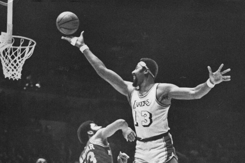 The Lakers Wilt Chamberlain gets off a finger roll against Milwaukee Bucks Kareem Abdul–Jabbar.
