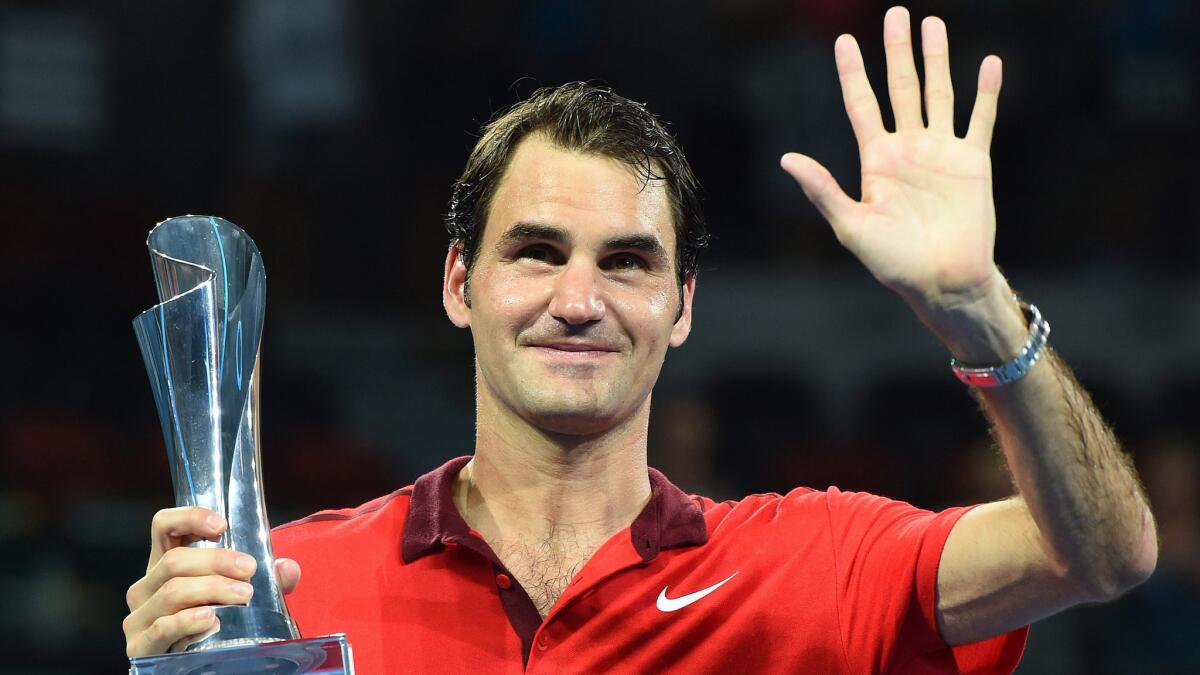 Roger Federer waves to the crowd after recording his 1,000th career win with a victory over Milos Raonic in the Brisbane International final in Australia on Sunday.