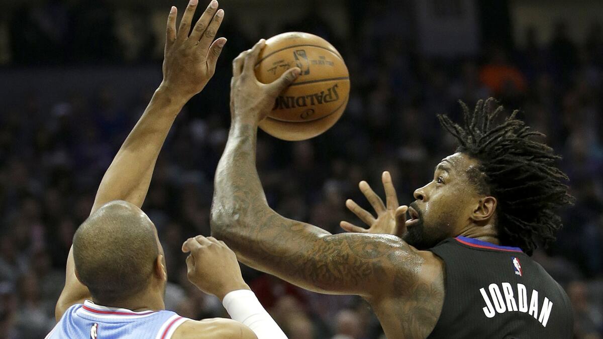 Clippers center DeAndre Jordan looks to score against the defense of Kings guard Arron Afflalo during the first half Friday night.