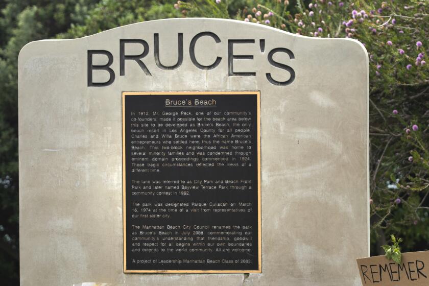 MANHATTAN BEACH, CA -JULY 29, 2020: A commemorative plaque at Bruce's Beach, a park located in Manhattan Beach, explains the history of the area. Bruce's Beach used to be owned by one of the first prominent Black oceanfront homeowners (in the 1920's) but Manhattan Beach ran them out of town and erased/rewrote the history of what happened. A new generation of residents are now calling on the city to confront its racist past. Many have reclaimed the space in recent weeks to celebrate and honor the Black Lives Matter movement. (Mel Melcon / Los Angeles Times)