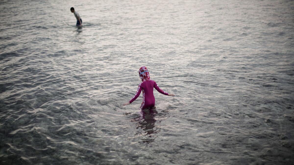 Children swim off of an atoll in the Maldives in February 2016. The United States, China and other countries issued travel advisories after the president of the archipelago nation imposed a state of emergency.