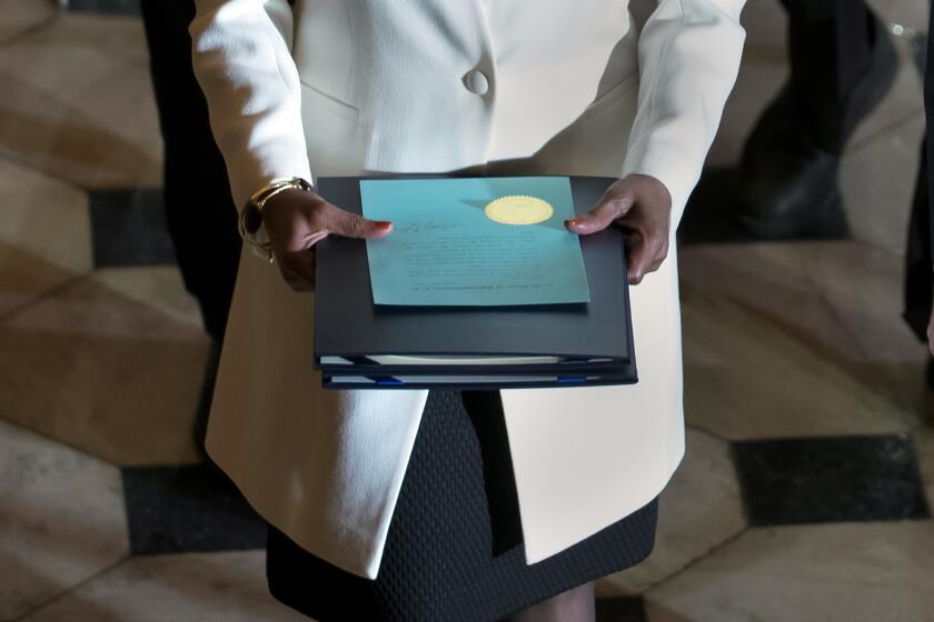 Clerk of the House Cheryl Johnson carries the articles of impeachment against President Donald Trump to the Senate, on Capitol Hill in Washington, Wednesday, Jan. 15, 2020. (AP Photo/J. Scott Applewhite)