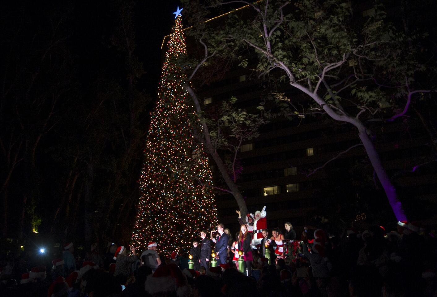 Santa Claus and the Segerstrom family light the Christmas tree during South Coast Plaza's 34th annual tree lighting ceremony on Thursday.