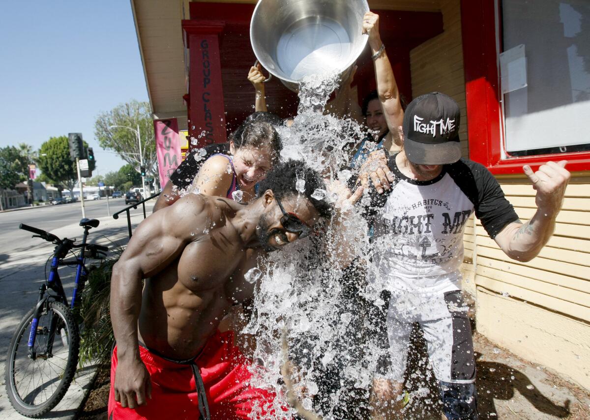 Fitness is Art members Antjuane Sims, front left, Paulina Fichtenmayer, rear left, and Martin Naborowski, front right, do the ALS Ice Bucket Challenge.