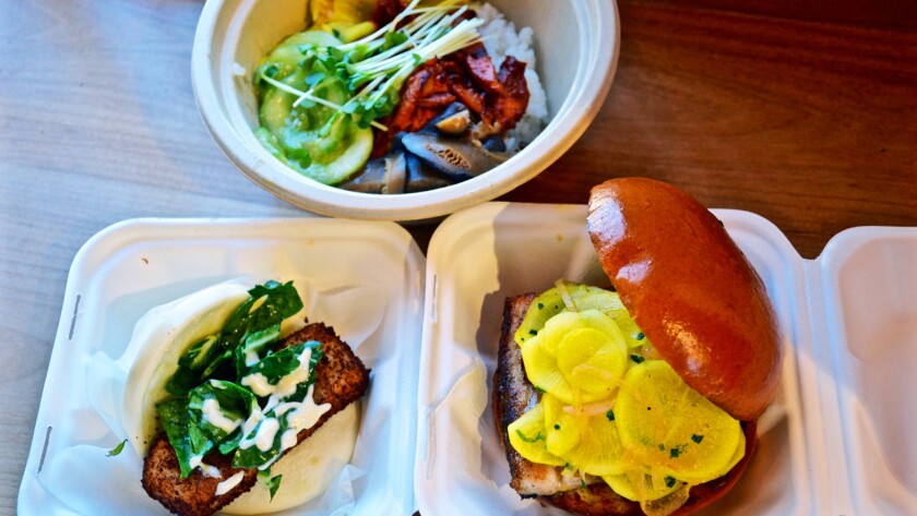 A selection of dishes, including steamed, left, and baked, right, bao from the Chairman, a new restaurant in the downtown Arts District.