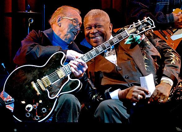 Music legends Les Paul, 88, left, and B.B. King, 77, put their heads together during a jam session at the third anniversary celebration of the B.B. King Blues Club and Grill in New York's Times Square, Tuesday night June 17, 2003. Paul holds King's signature "Lucille" guitar, which he played.(AP Photo/Richard Drew)