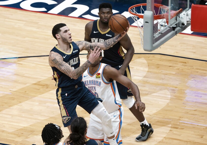 New Orleans Pelicans guard Lonzo Ball (2) shoots past Oklahoma City Thunder center Al Horford (42) in the fourth quarter of an NBA basketball game in New Orleans, Wednesday, Jan. 6, 2021. (AP Photo/Derick Hingle)